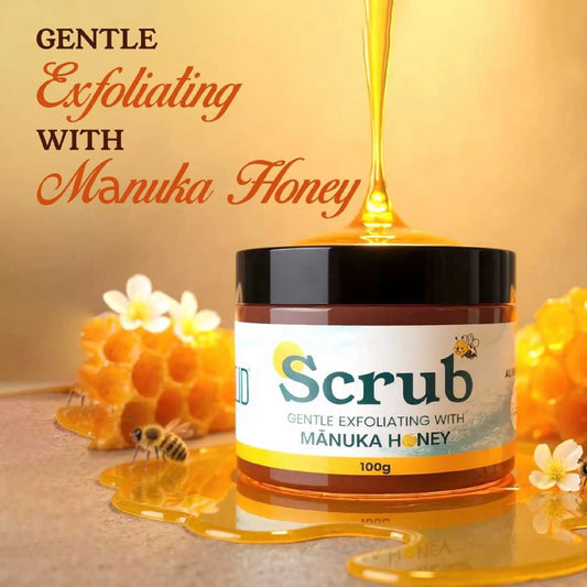 Jar of scrub with manuka honey being poured over it, surrounded by honeycomb and flowers.